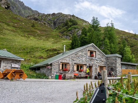 A cozy stone house in a picturesque mountain landscape.  
Surrounded by green meadows and mountains, it is an idyllic retreat.